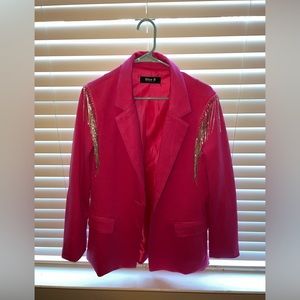 A hot pink blazer with rhinestones on the shoulders